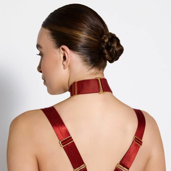 Photo of a Woman from the Back wearing a Necklace with Red Color Ring