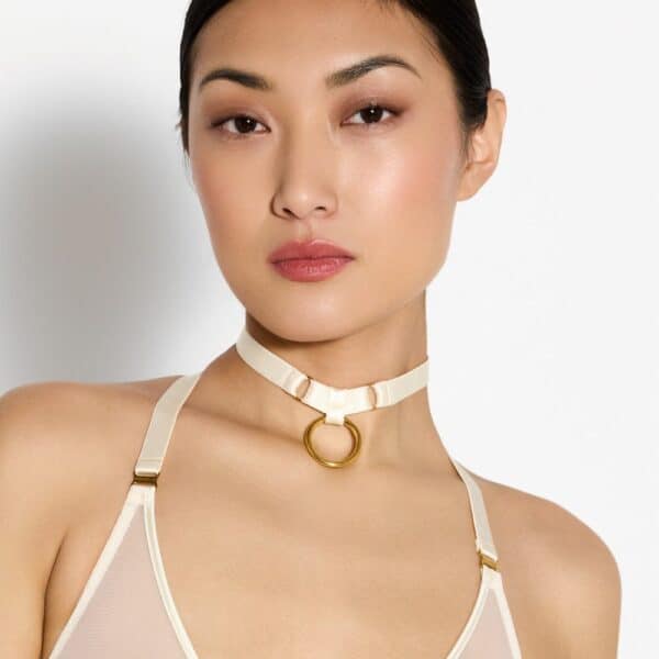 Photo of a Woman from the Front wearing a Mesh Crossed Bra and a Necklace with Cream-colored Ring