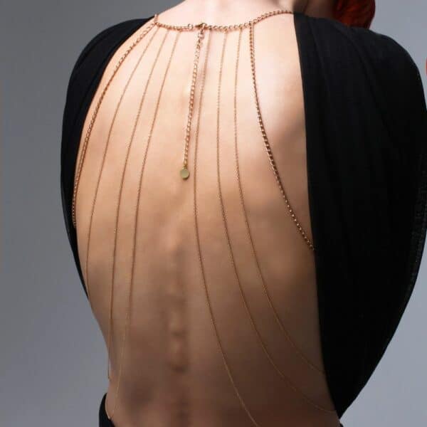 Photo of a Woman from the Back wearing a Gold Body Jewelry with Swarovski Jewelry with a Black Outfit