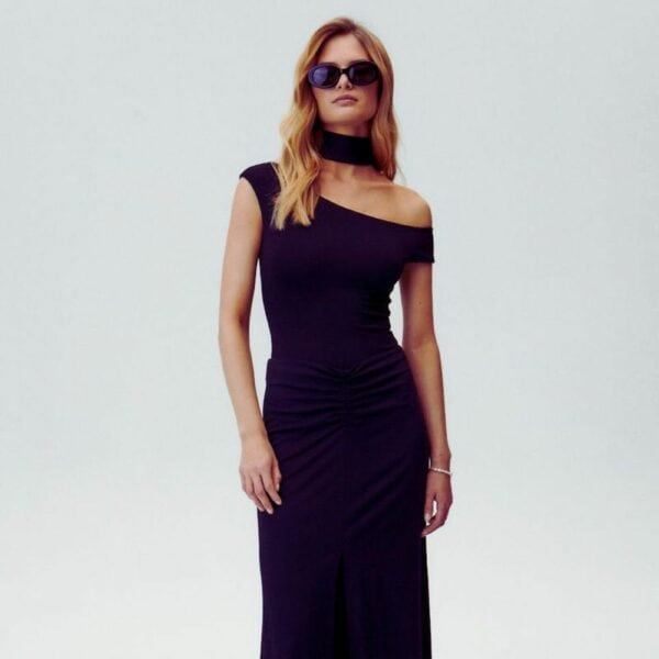 Photo of a Woman from the Front wearing an Opaque Asymmetrical Bodysuit and a Long Black Skirt