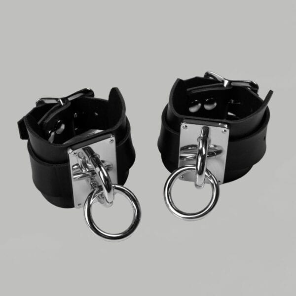 Packshot Black Leather Wristcuffs with Buckle and Silver O Strap