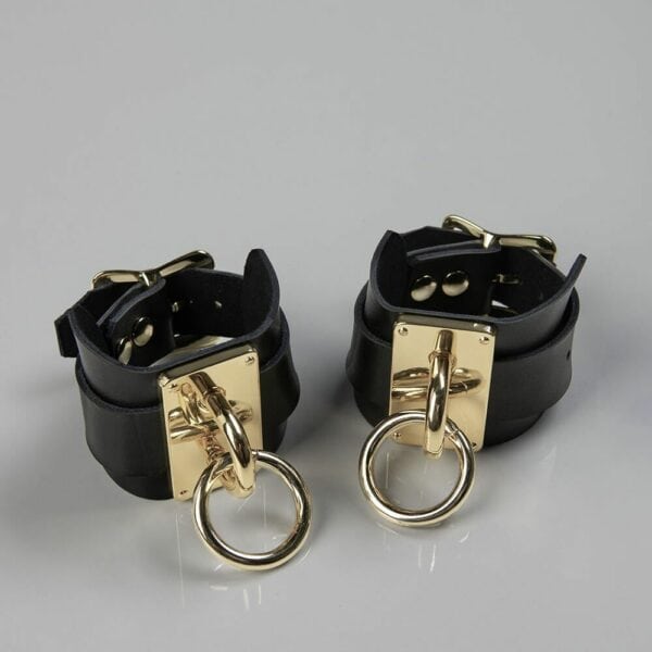 Packshot Black Leather Handcuffs with Gold Buckle and O-Ring