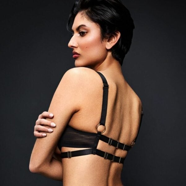 Bold, elegant lingerie in black tulle with harness and sensual cut-outs.